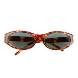 GUCCI - a pair of sunglasses. Designed with imitation tortoiseshell acetate frames, green tinted