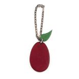 HERMÈS - a fruit key chain. Designed as a burgundy calfskin leather plumb with green leather leaf to