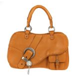 CHRISTIAN DIOR - a Gaucho Stitched Saddle handbag. Designed with a grained orange leather exterior