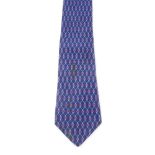 HERMÈS - a silk tie. A dark blue tie featuring a light blue linked pattern with red accents.