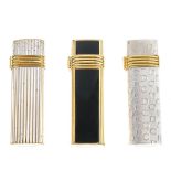 CHRISTIAN DIOR - three lighters. To include two silver-tone examples, together with a gold-tone