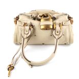 CHLOÉ - a mini Paddington handbag. Featuring a beige calfskin leather exterior, dual rolled