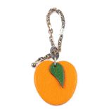 HERMÈS - a fruit key chain. Designed as an apricot in orange leather to the silver-tone chain. Green