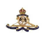 A mid 20th century enamel Royal Artillery brooch. The textured cannon, with blue enamel ribbon motto