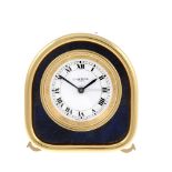 A desk clock by Cartier. Gold plated case with blue enamel surround. Reference 7504, serial 07035.