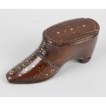 A treen novelty snuffbox, modelled as a shoe, with sliding lid, the whole with brass pin pique