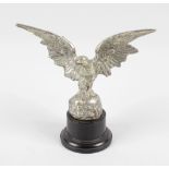 A chromed cast metal pocket watch stand, modelled as an eagle with spread wings, upon a rocky