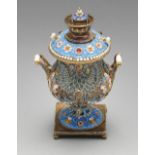 A miniature Russian samovar, decorated in cloisonné enamel with a twin-headed eagle having spread