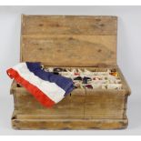 An early 20th century stripped pine box and hinged cover of trunk form, containing a selection of