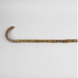 A 19th century bentwood Folk Art walking cane, of rustic form, the whole hand painted with