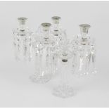 A pair of 19th century cut glass candlesticks, each with a hollow spreading hexagonal shaped column,