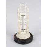 A 19th century Anglo Indian carved ivory desk thermometer, the mercury filled glass tube upon an