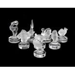 A group of eight Lalique glass menu or place card holders. Each with slot to integral circular base,