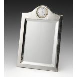 A George V silver mounted mirror, the plain shaped rectangular form with easel support back, inset