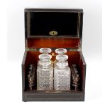 A late 19th century ebonised decanter box, having banded brass inlay and a vacant cartouche and