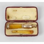 An amber cheroot holder, the body of tapering form with 9ct gold mounts, (a/f), 4.5 (11.5cm) long,