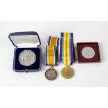 A box containing a 1914-1918 British War Medal and similar Victory Medal, to 35711 PTE J Sanderson