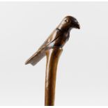A 19th century carved wooden walking cane, the handle modelled as a perched bird, the cane carved