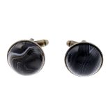 A pair of agate cufflinks. Designed as circular banded agate cabochons, to the hinged backs. Lengths