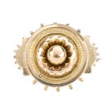 A late Victorian memorial brooch. The circular outline, with dome to the centre, scalloped