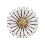 GEORG JENSEN - an enamel brooch. Designed as a daisy, with white enamel petals, to the textured