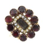 A composite mid Victorian memorial ring. The ring adapted from a brooch, with garnet surround to the