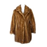 A pastel mink fur coat and jacket. The mid length mink coat featuring a notched lapel collar, hook