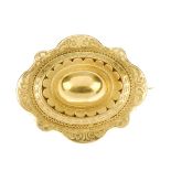 A late Victorian memorial gold brooch. Of oval outline, the domed panel with scalloped edge,