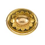 A late Victorian 15ct gold memorial brooch. Of oval outline, the tiered design with domed centre and