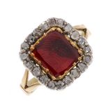 An early 19th century gold, foil back garnet and diamond cluster ring. The garnet of rectangular