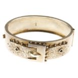 A late Victorian silver buckle bangle. Designed as a buckle with ivy engraved to it and beaded