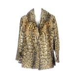 An ocelot fur jacket. Featuring a notched collar, hook and eye fastening and small side splits.