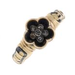 A mid Victorian gold diamond and enamel memorial ring. Designed as a black enamel flower shape,