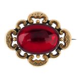 A late 19th century memorial brooch with replacement stone. The central oval-shape replacement red