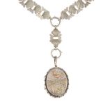 A late Victorian silver locket and collar. The collar designed as a series of bow-shape links each