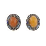 A Chinese natural amber silver gilt ring and pair of ear clips. The ring designed as an oval shape