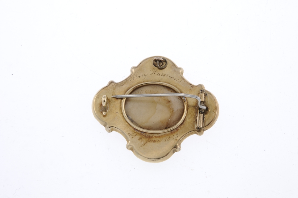 A mid Victorian memorial enamel and split pearl brooch. Of quatrefoil outline, the central oval- - Image 2 of 2