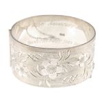 Four silver hinged bangles. All engraved with scrolling acanthus or floral decoration. All with