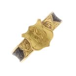 An early 20th century 18ct gold and hair memorial monogram ring. The monogrammed shield shape