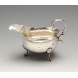 A George III silver small sauceboat, the typical bellied form with scalloped rim, foliate capped