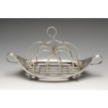 A George III silver toast rack, the navette form within beaded border and twin reeded handles