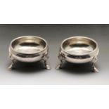 A pair of early George III silver open salts, each of plain cauldron form with ribbed rim and raised