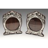 A pair of Art Nouveau silver mounted photograph frames, the circular aperture with shaped surround