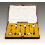 A 1920's cased set of six silver coffee spoons, each with black bean terminal, hallmarked Cooper