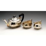 A 1930's three piece silver tea service including a teapot, twin-handled sugar bowl and cream jug,
