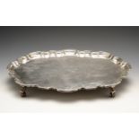 A mid-twentieth century silver salver, of oval form with Chippendale style rim and raised on four