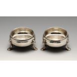 A pair of George II silver open salts, each of plain cauldron form with moulded rim and raised on