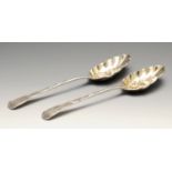 A selection of silver to include a pair of George III silver berry spoons, each with embossed floral