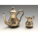 A German silver coffee pot and cream jug, each of bellied form having twin opposed cartouche