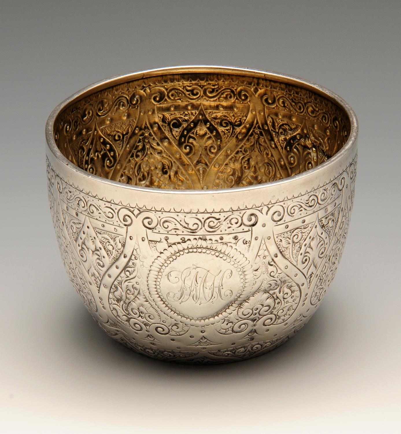 A late Victorian silver bowl, the circular slightly tapering form ornately chased throughout with
